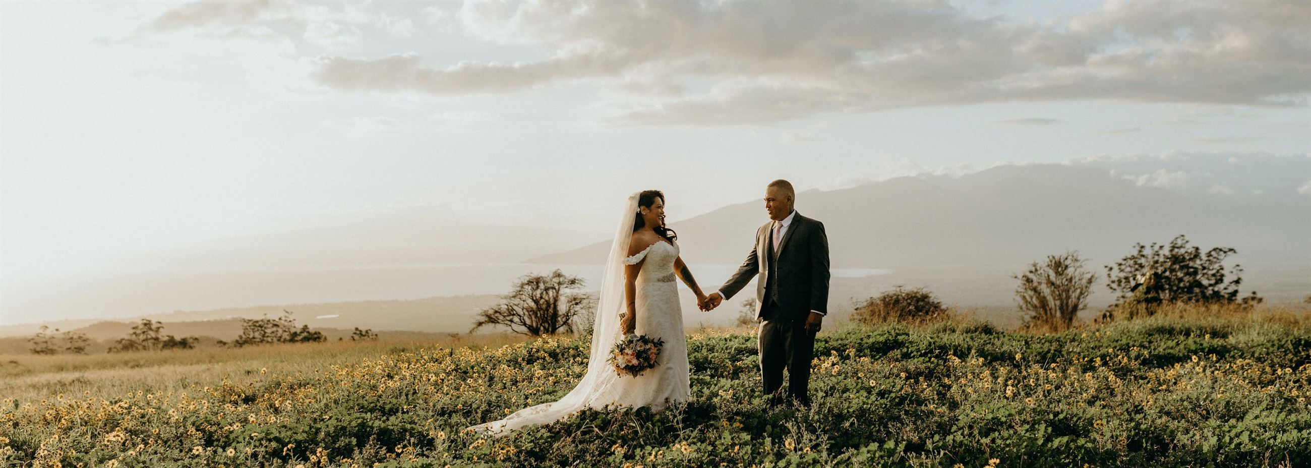 Сouple wearing a white gown and a black suit