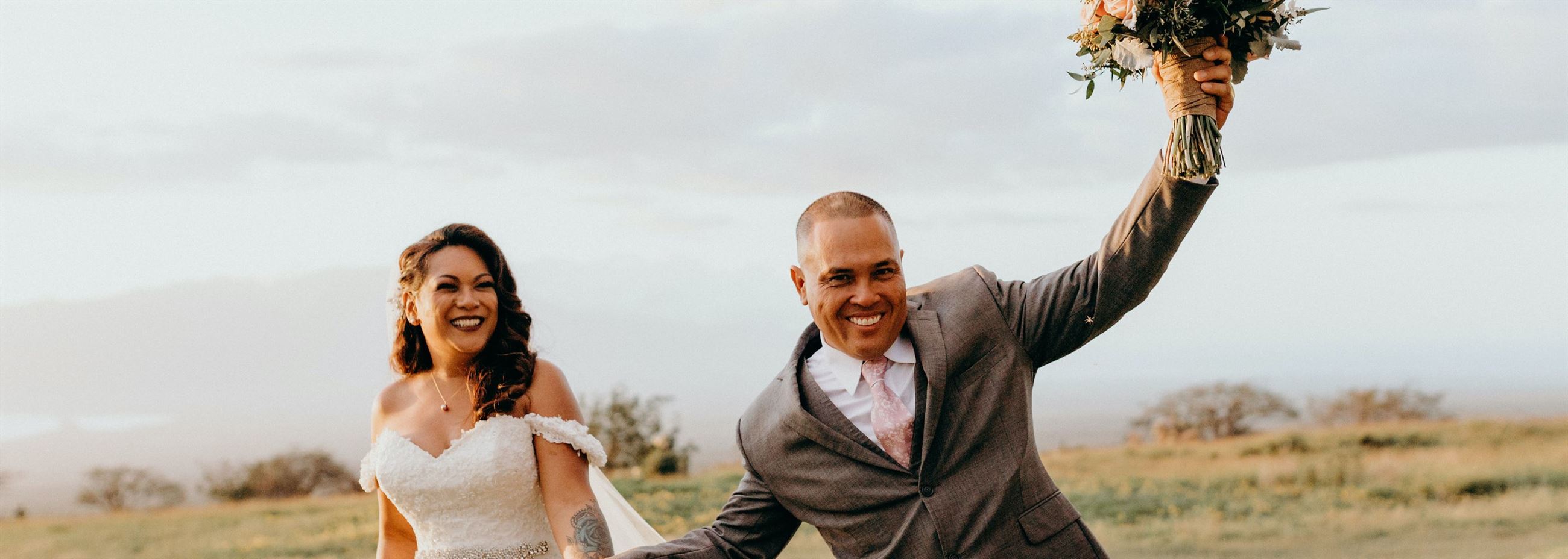 Сouple wearing a white gown and a gray suit